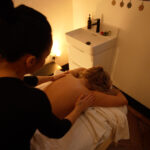 Woman receiving a body massage at Angel Wellness Retreat in Essex.