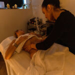 A woman is receiving a lymphatic drainage massage by another woman.