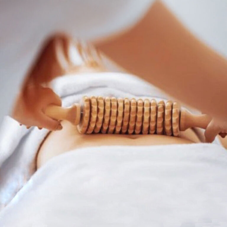 A wooden tool being rolled down someones stomach.