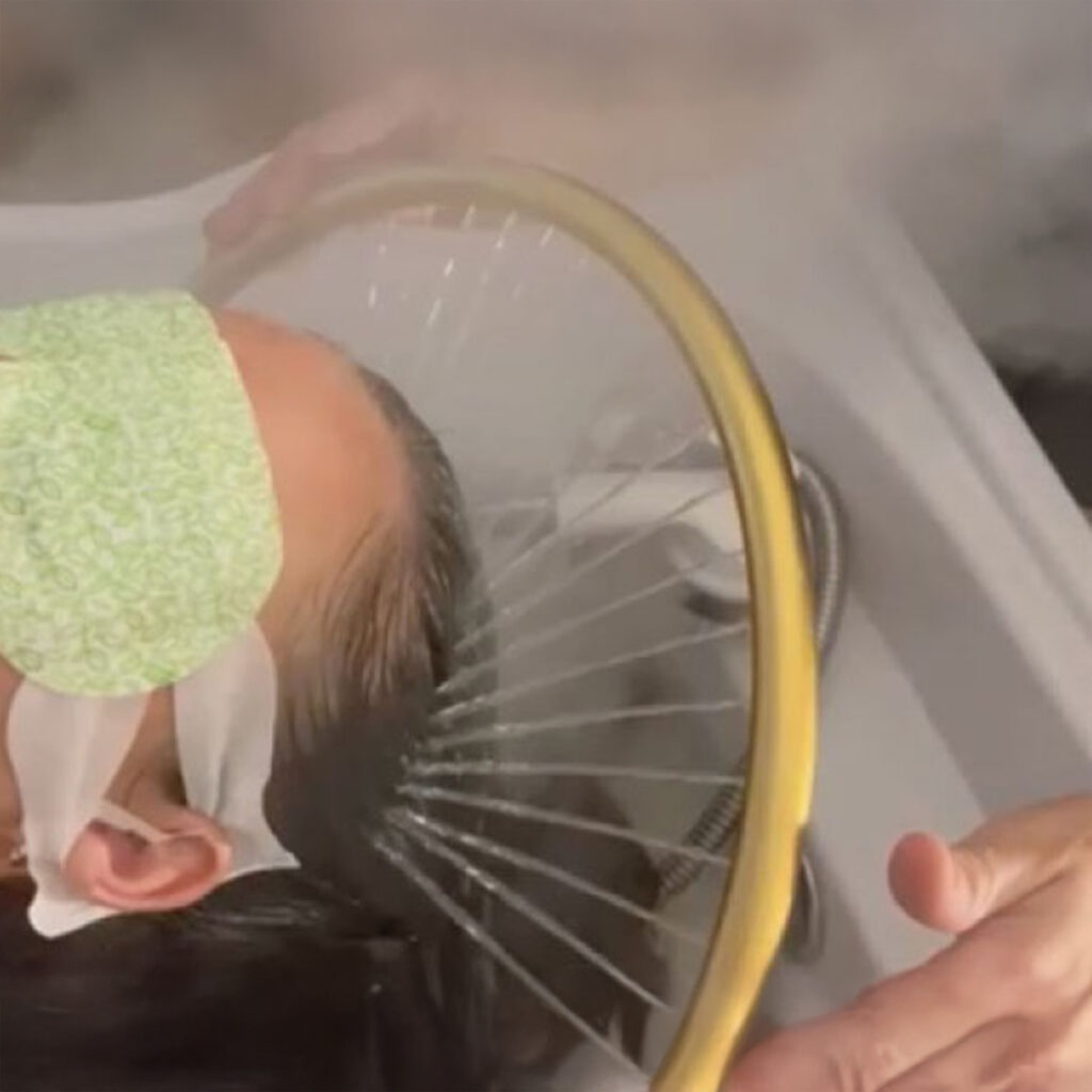A woman is having a Japanese Head Spa massage.