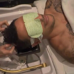 A man is lying in a salon chair, receiving a Japanese head spa treatment, with an eye mask over his eyes.