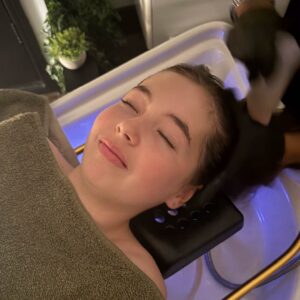 A young girl getting a Japanese Head Spa at Angel Wellness Retreat.