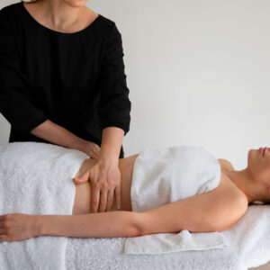 A woman is receiving a massage from another woman.
